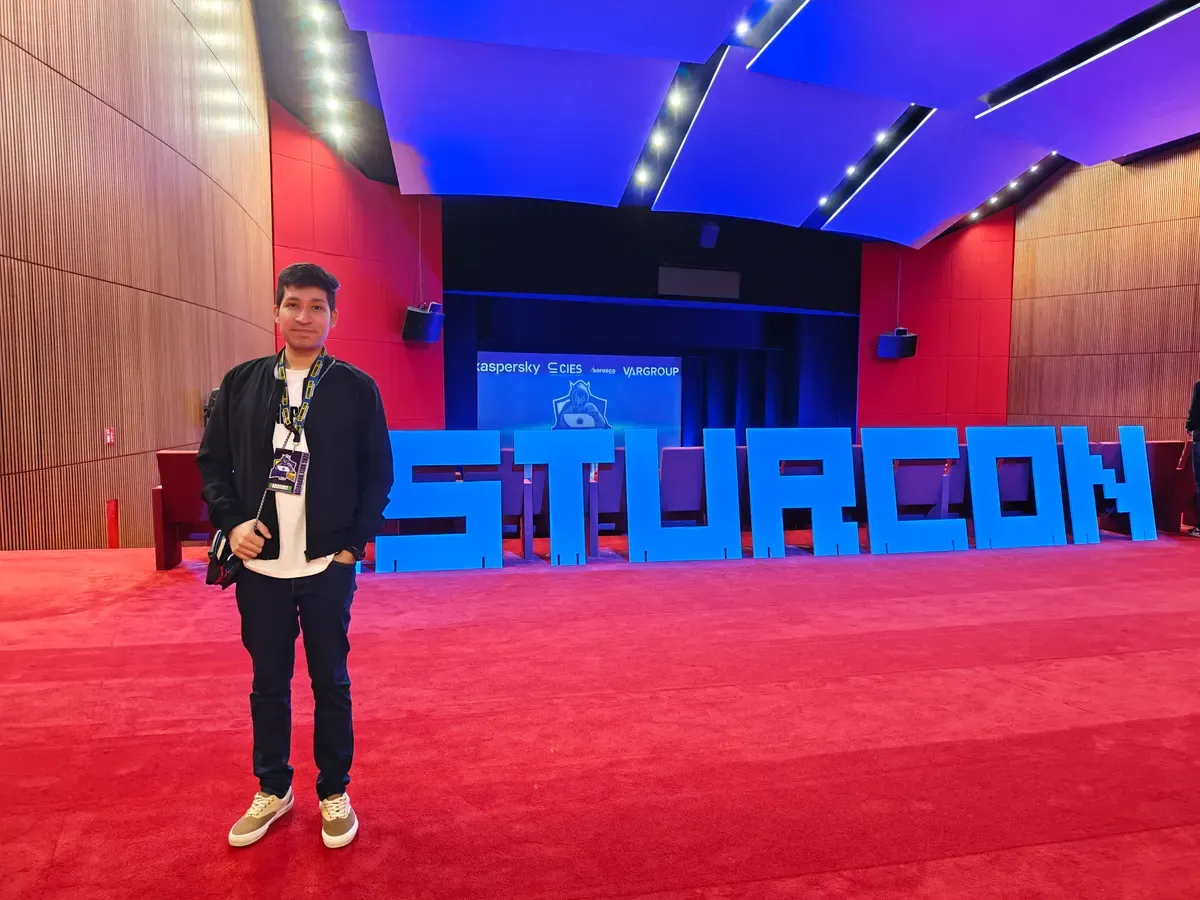 Bray Lozano in front of the large AsturCON lettering in the conference foyer