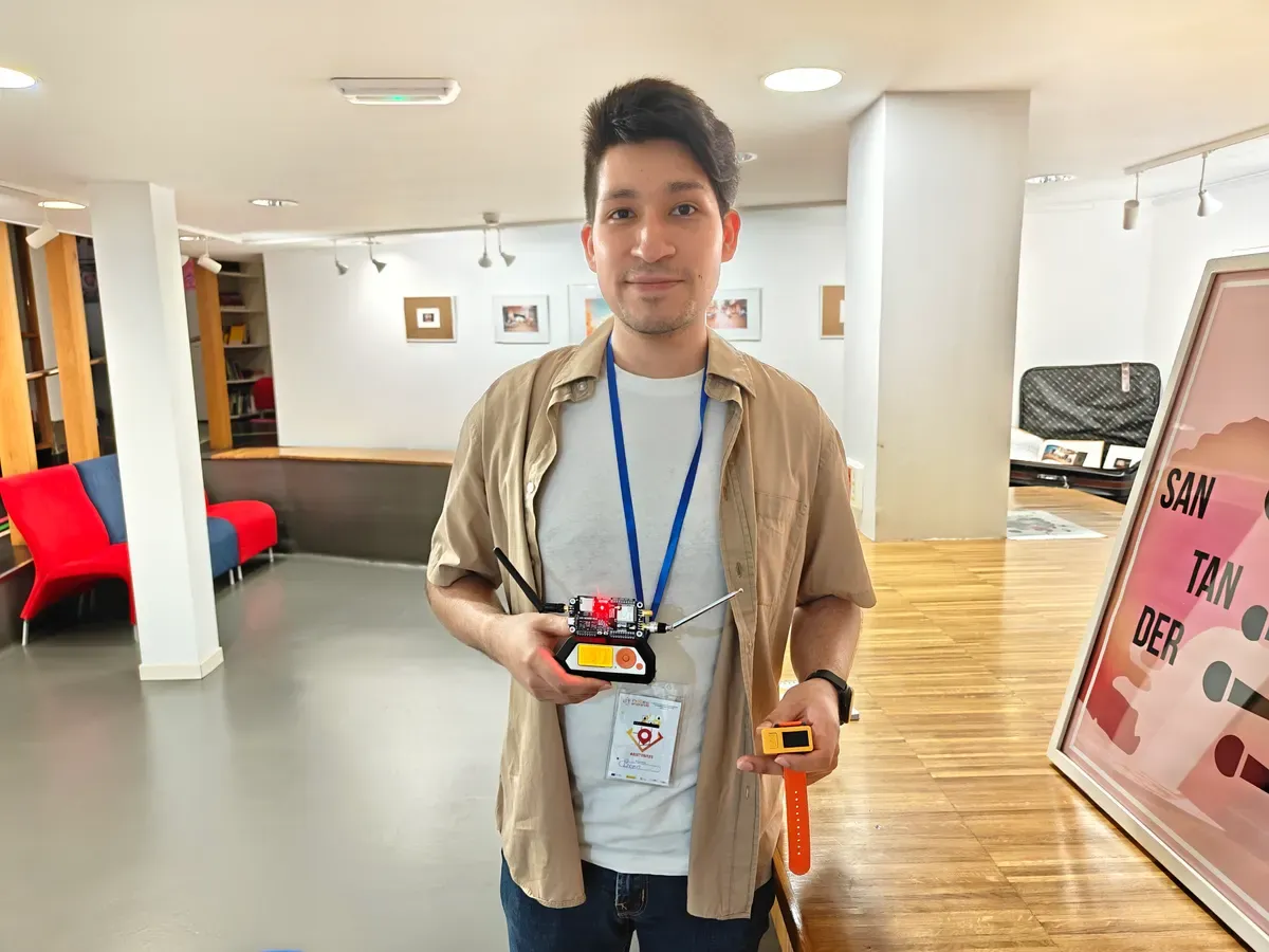 Bray Lozano holding the ethical hacking kit from the workshop, with his badge on