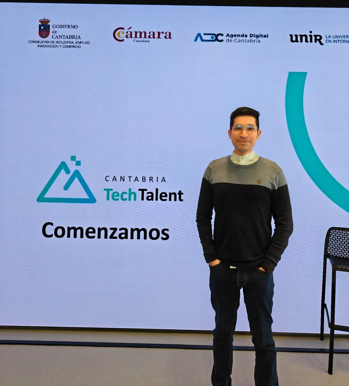 Bray Lozano standing in front of the Cantabria Tech Talent sign at the opening event